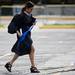 A UM graduate tiptoes over cracks and rushes to Spring Commencement on Saturday, May 4. Daniel Brenner I AnnArbor.com